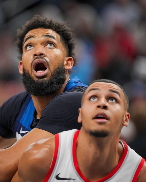 Mar 4, 2024; Minneapolis, Minnesota, USA; Minnesota Timberwolves center Karl-Anthony Towns (32) rebounds against the Portland Trail Blazers forward Kris Murray (8) in the third quarter at Target Center.